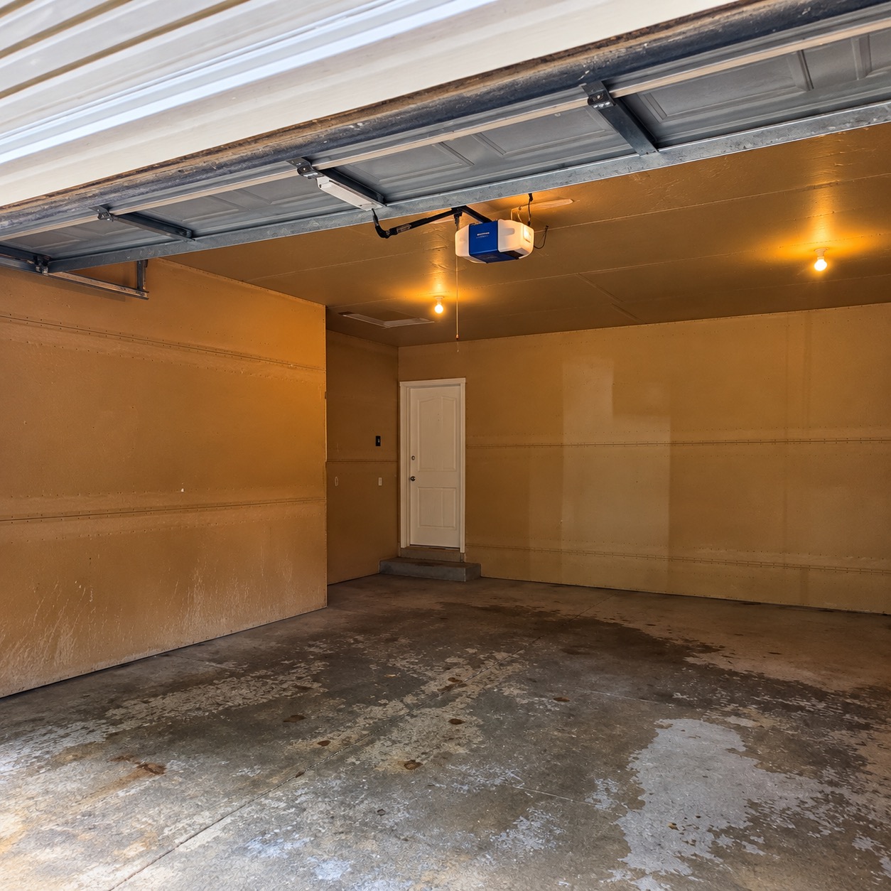 The same garage before coating: stained, salt-scarred bare concrete